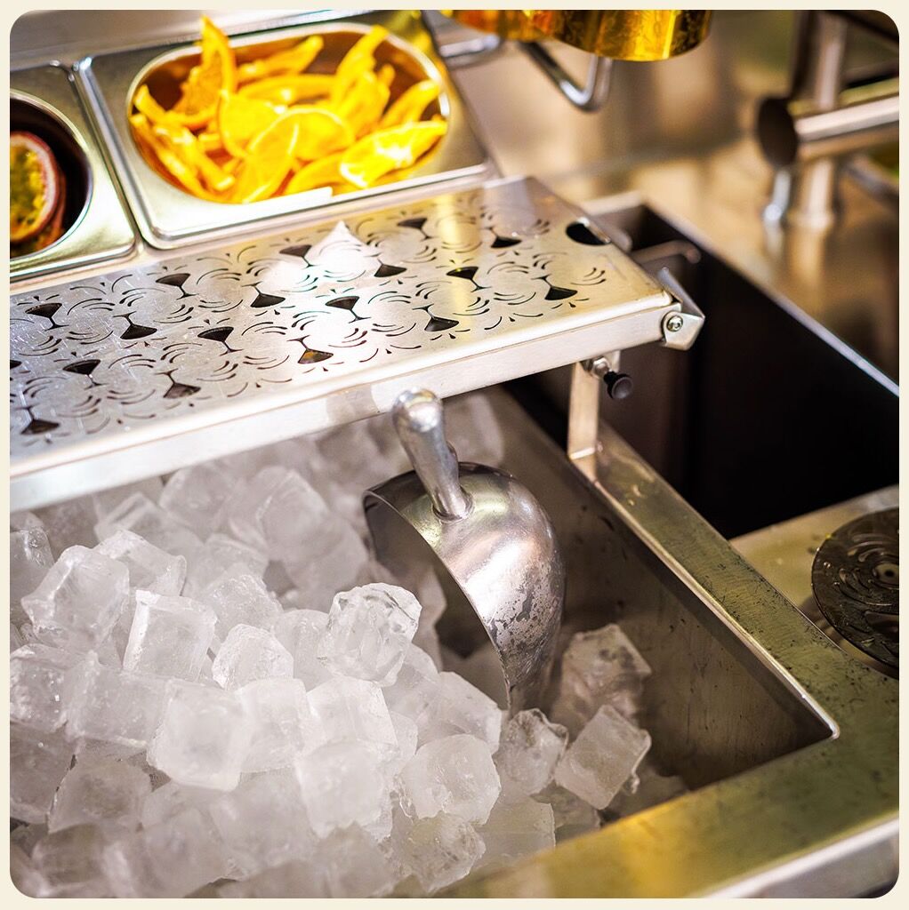 The station in use behind the bar, crushed ice and garnishes prepared