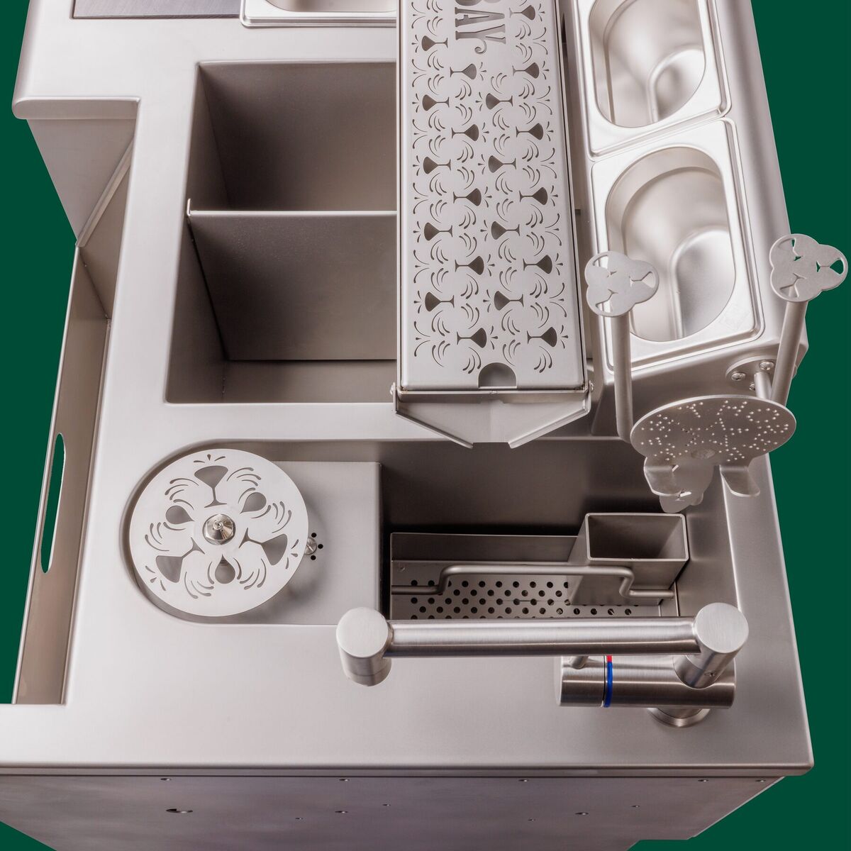 Detail of the work surface with garnish trays, glass rinser and engraved panel